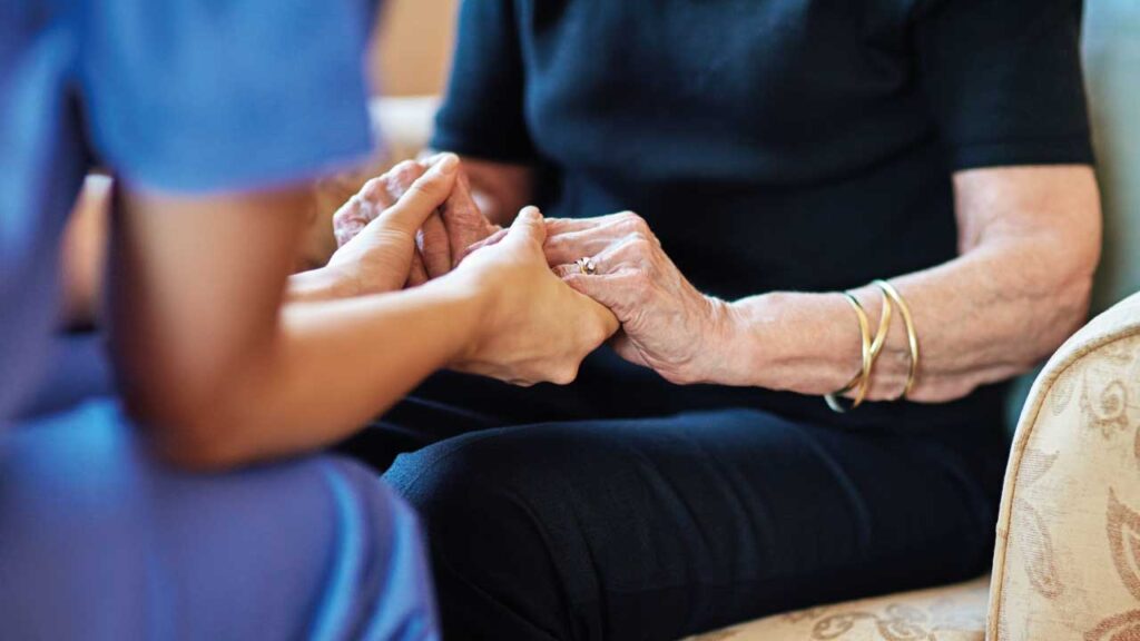 elderly woman being supported by an informal carer