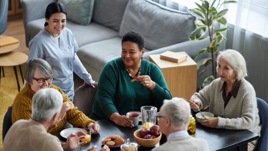 older people socialising at the table in a day centre