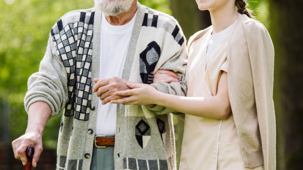a carer out for a walk with an older person