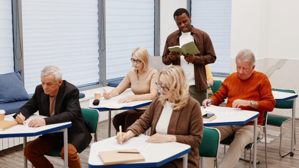 Senior adults sitting and learning in a school
