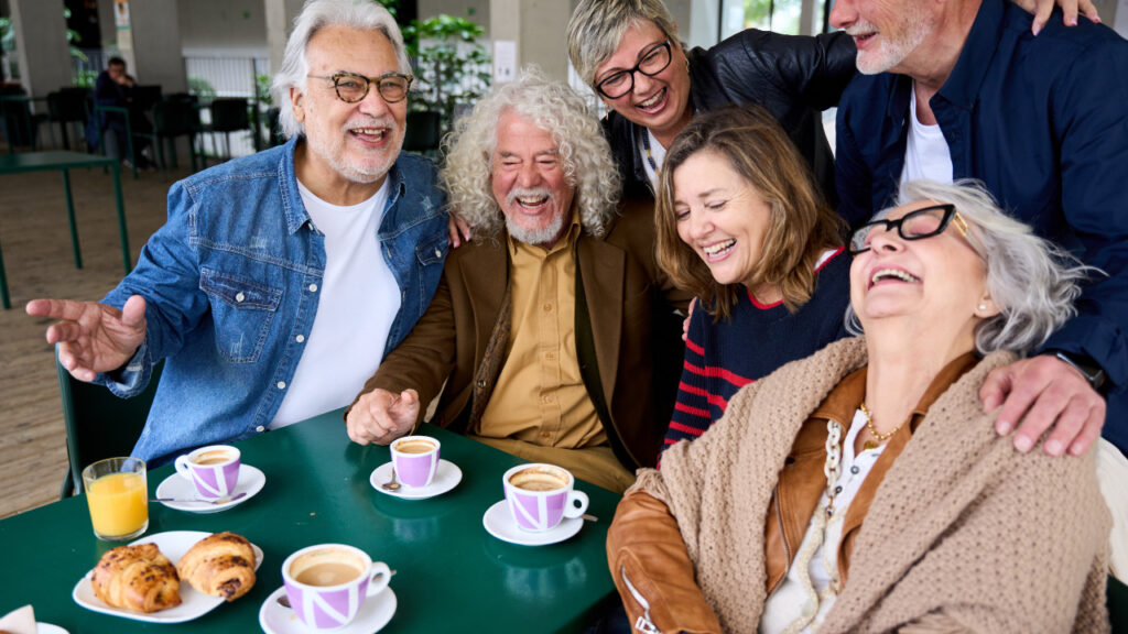 Group of older people having fun and enjoying a snack all together